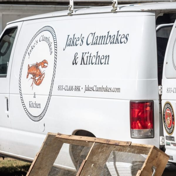White van with "Jake's Clambakes & Kitchen" logo featuring a red lobster, and contact information.