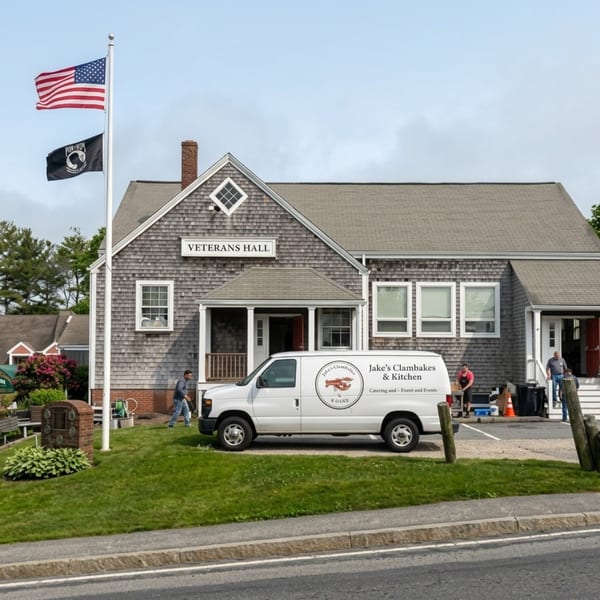 A white catering van from Jake's Clambakes & Kitchen is parked outside Veterans Hall.